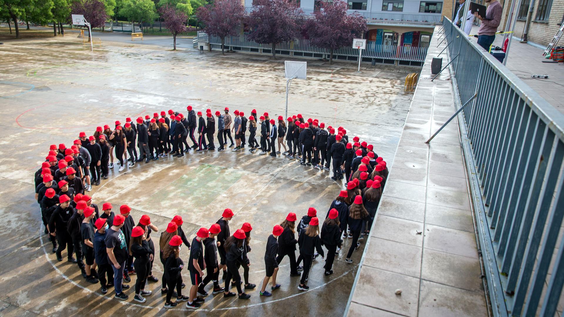Los alumnos caminando en círculo en el patio de Jesuitinas. Arriba se puede ver la cámara que filma sus movimientos
