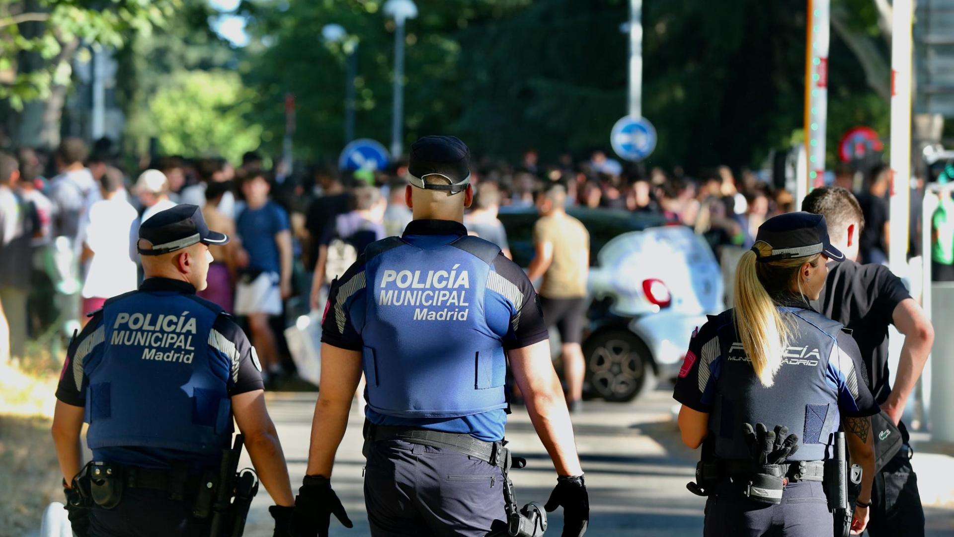 Varios policías controlan la multitud de estudiantes tras finalizar las pruebas de la EvAU en Madrid