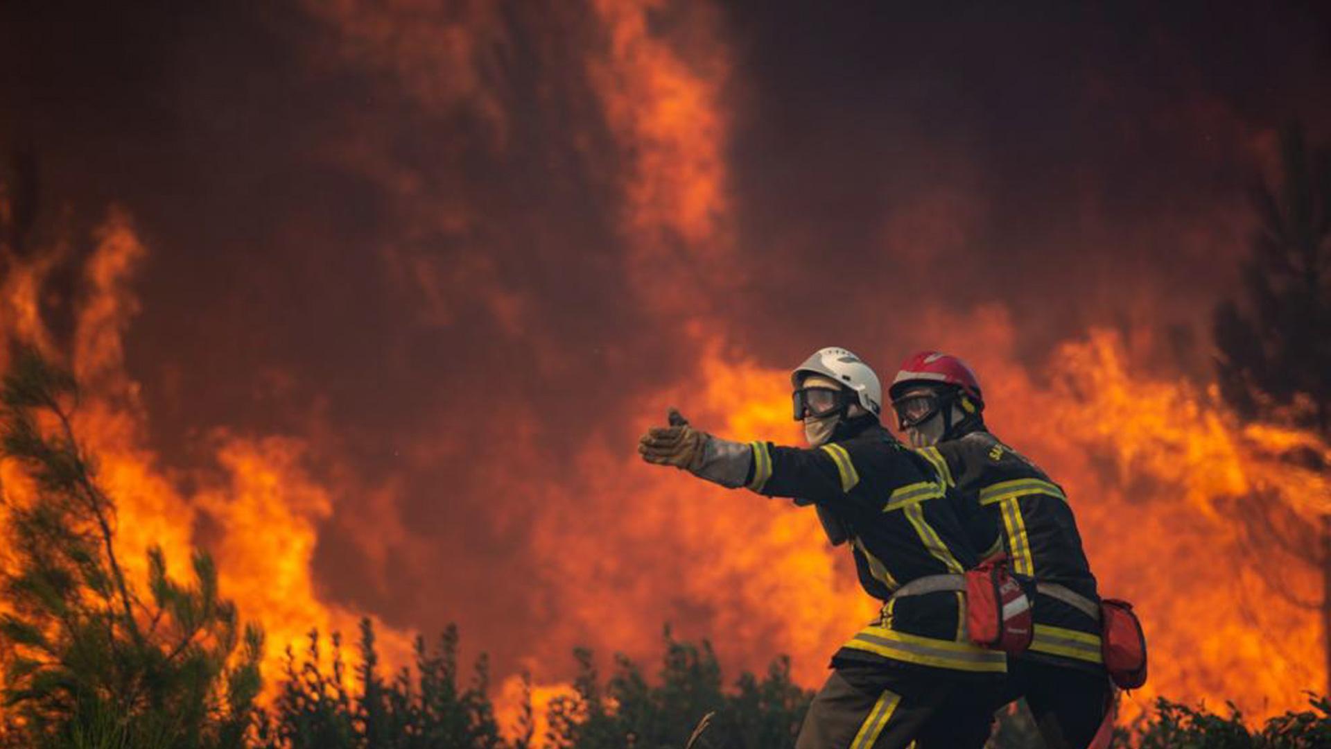 Dos bomberos trabajan en el incendio de Landiras, en el sur de Burdeos
