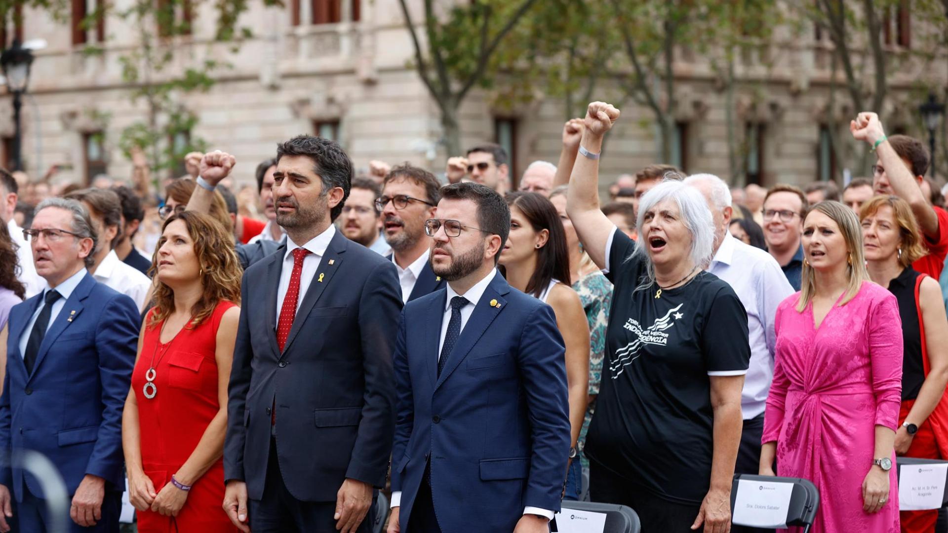El presidente de la Generalitat, Pere Aragonès (c), junto a Jordi Puigneró (3i), Laura Vilagrá (2i), Jaume Giró (i), y su esposa Janina Juli (d), durante el acto organizado por Òmnium Cultural con motivo de la Diada del 11 de septiembre, este domingo en Barcelona