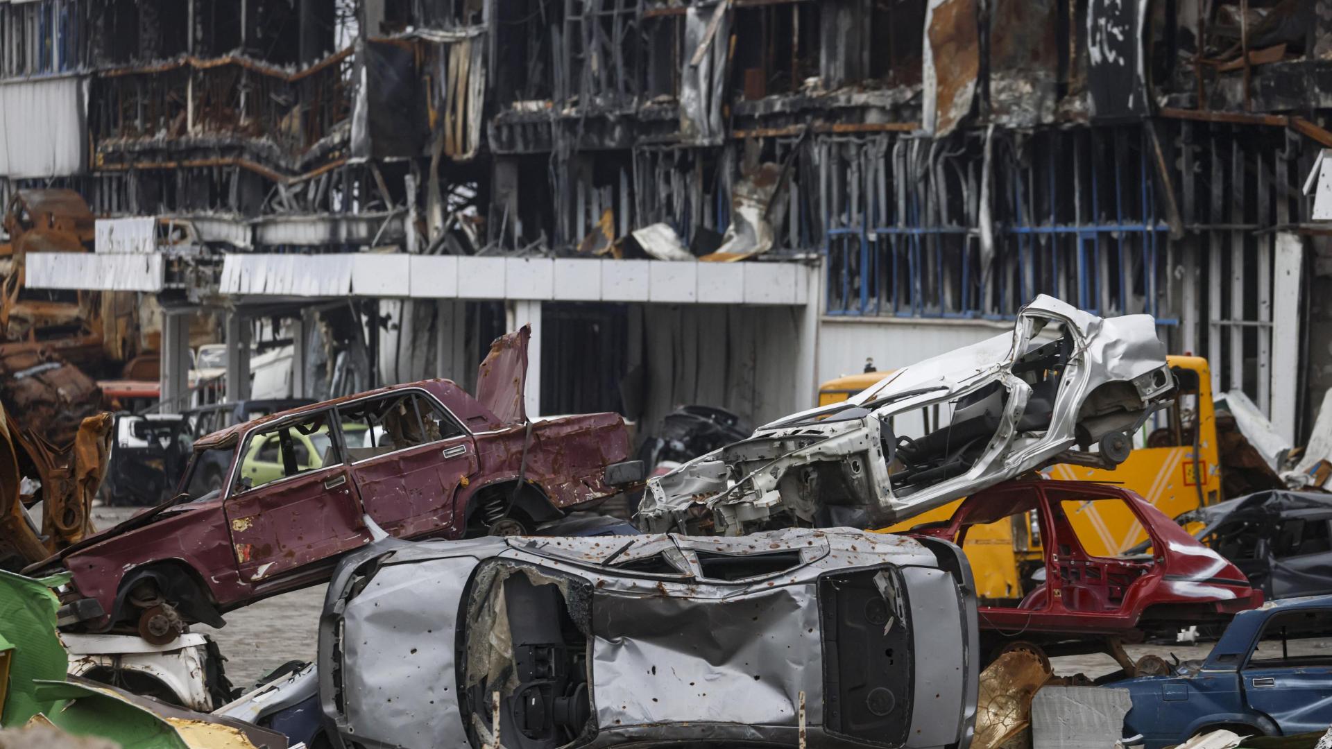 Vehículos destrozados apilados cerca de un centro comercial destruido durante un combate en Mariupol