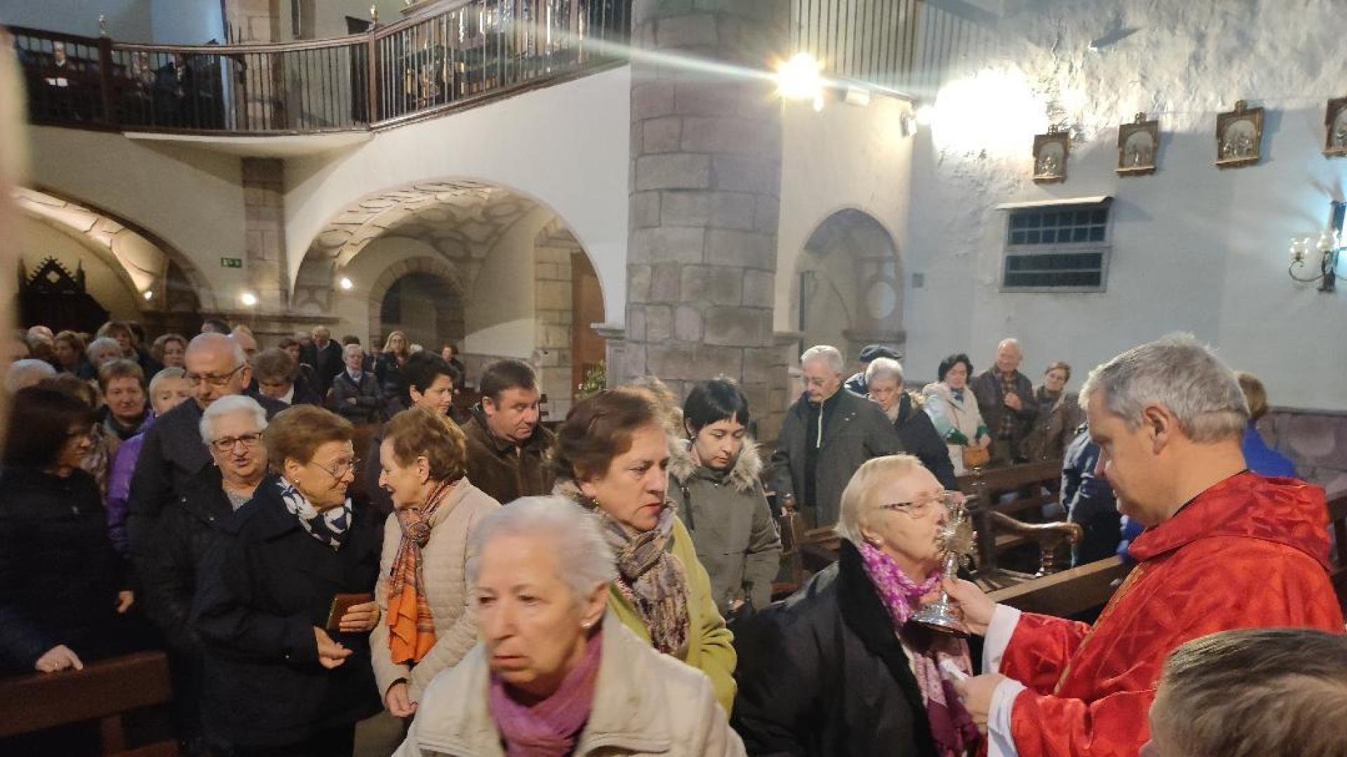 En la imagen, el párroco, Juan Zabala Osés, da de besar la reliquia de Santa Lucía a la conclusión de la eucaristía.