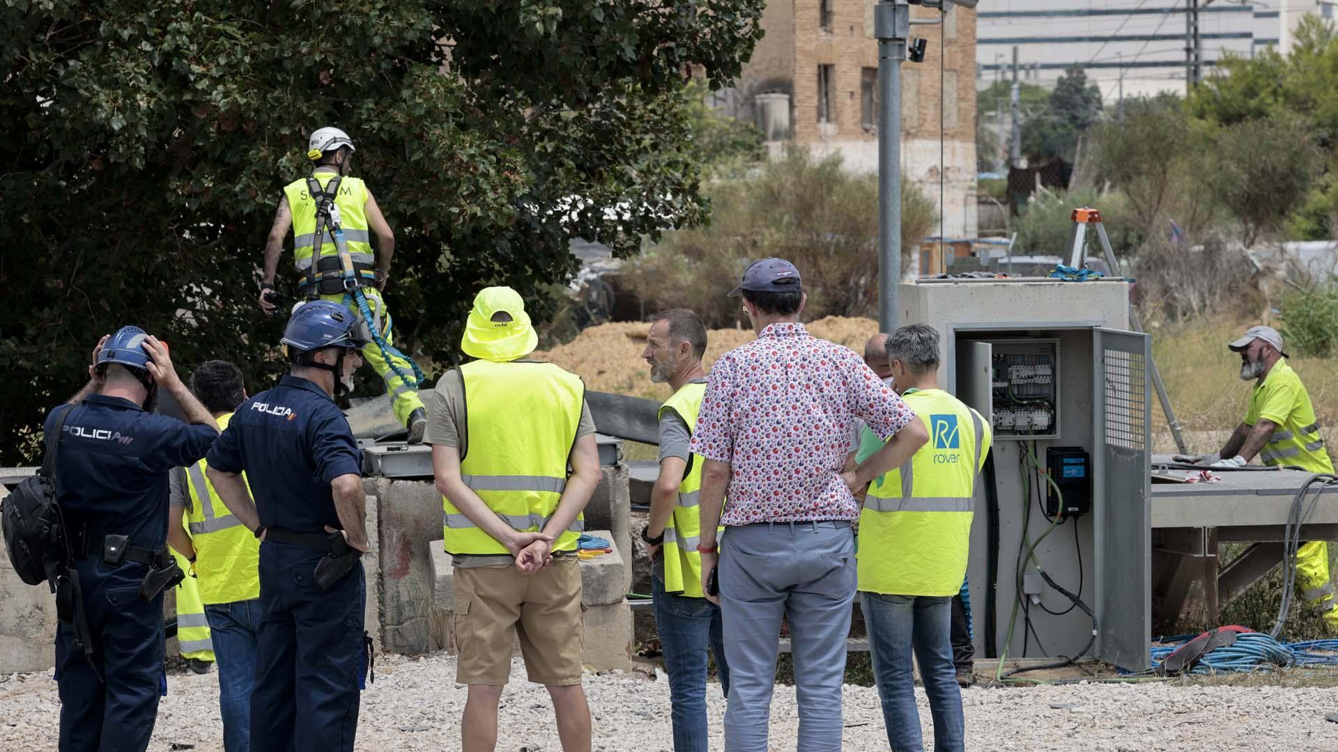 Personal de ADIF, operarios y agentes de la Policía Nacional trabajando para solucionar los incidentes provocados por un incendio en el pozo de bombas de agua del túnel de San Isidro, en la LAV Madrid-Valencia