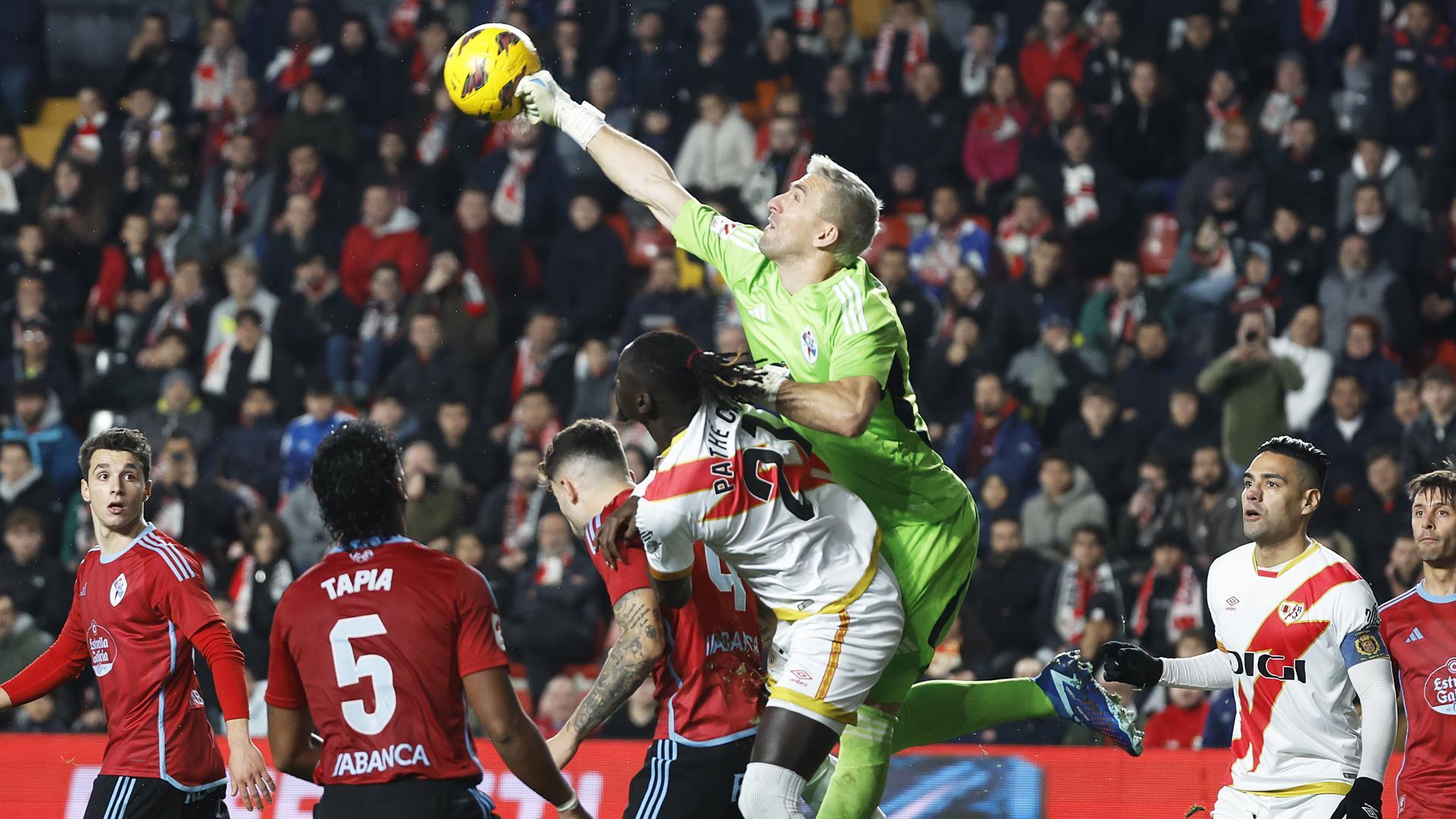 El meta del Celta, Guaita, despeja de puños saltando más que los rivales en una jugada dle partido./