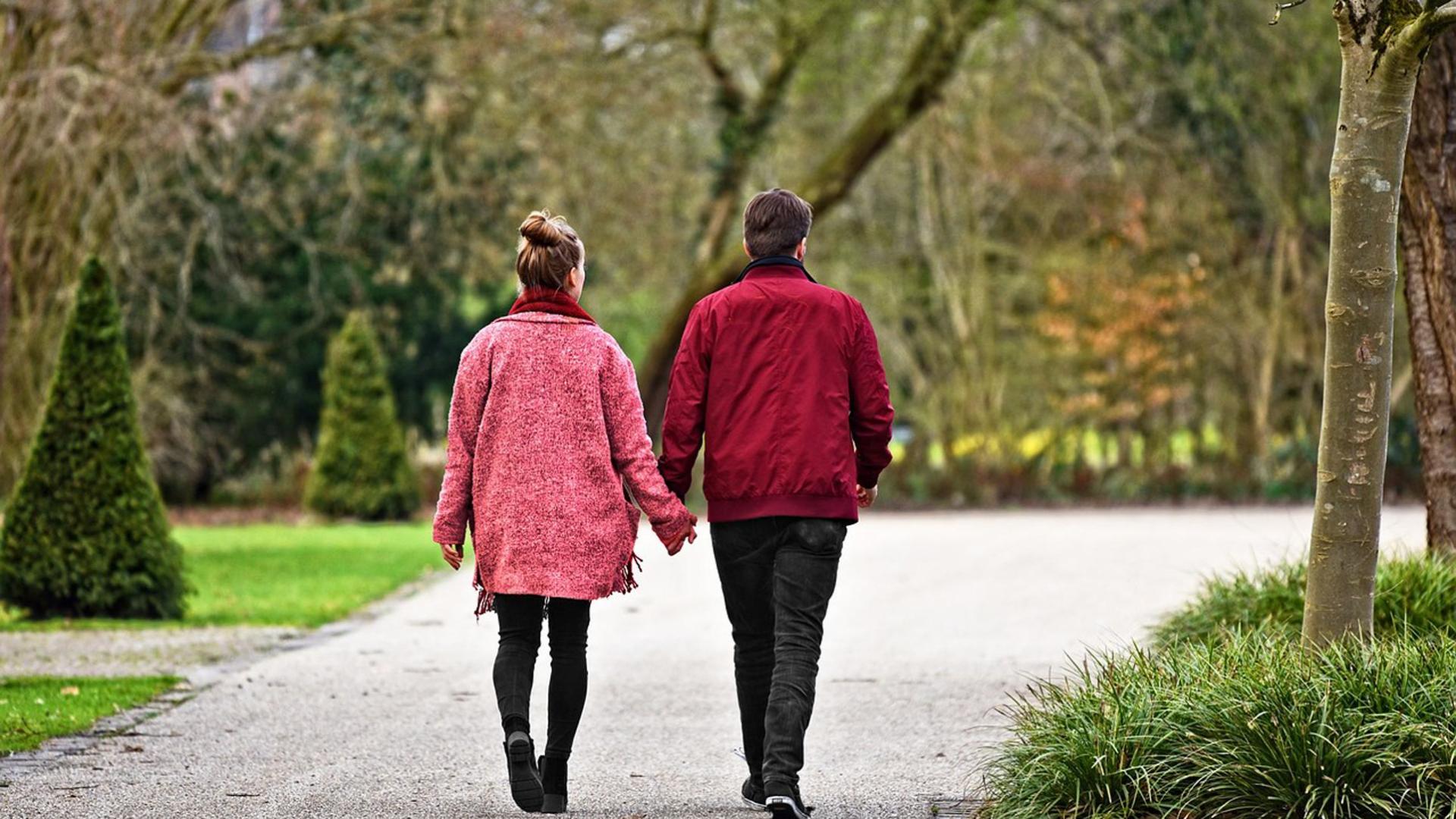 Una pareja pasea por un parque
