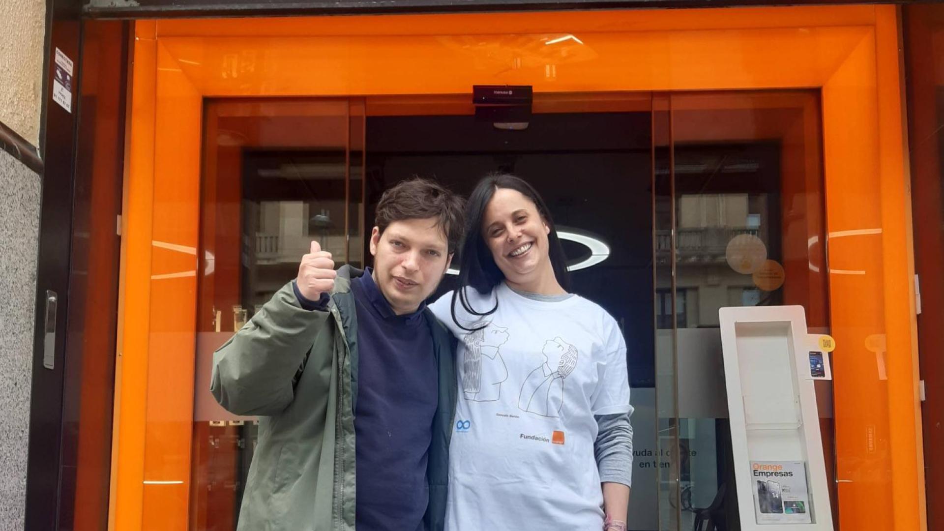 El pamplonés Gonzalo Bañón de Hoyos, con una de las empleadas de Orange que lleva la camiseta con su dibujo ganador.
