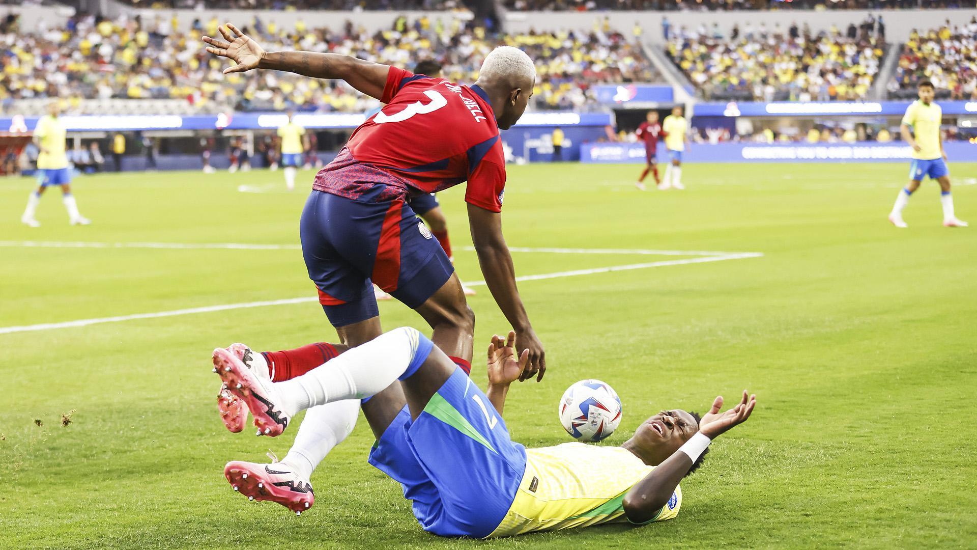 Vinícius Junior por los suelos tras perder un balón con el defensa de Costa Rica Jeyland Mitchell