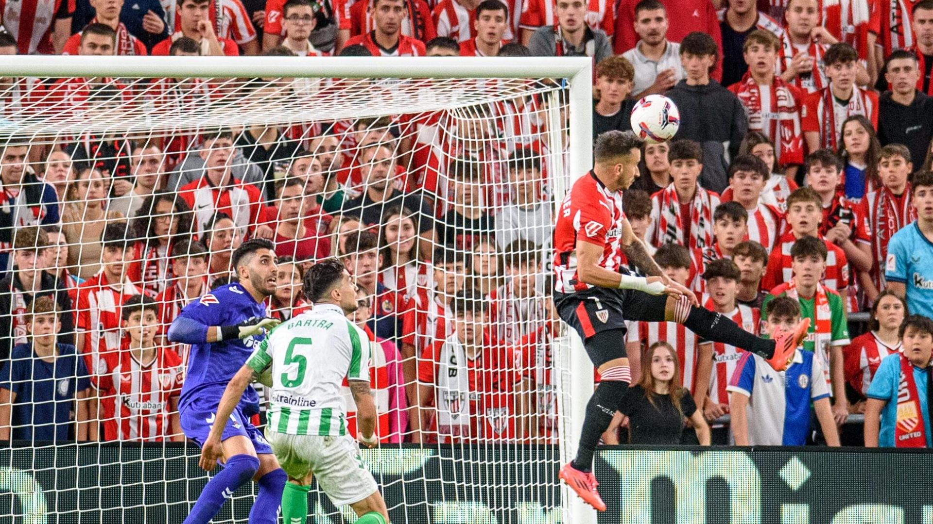 El delantero del Athletic Club de Bilbao Álex Berenguer (d) remata de cabeza para conseguir el gol del empate para el equipo bilbaíno, durante el partido de Liga en Primera División ante el Real Betis
