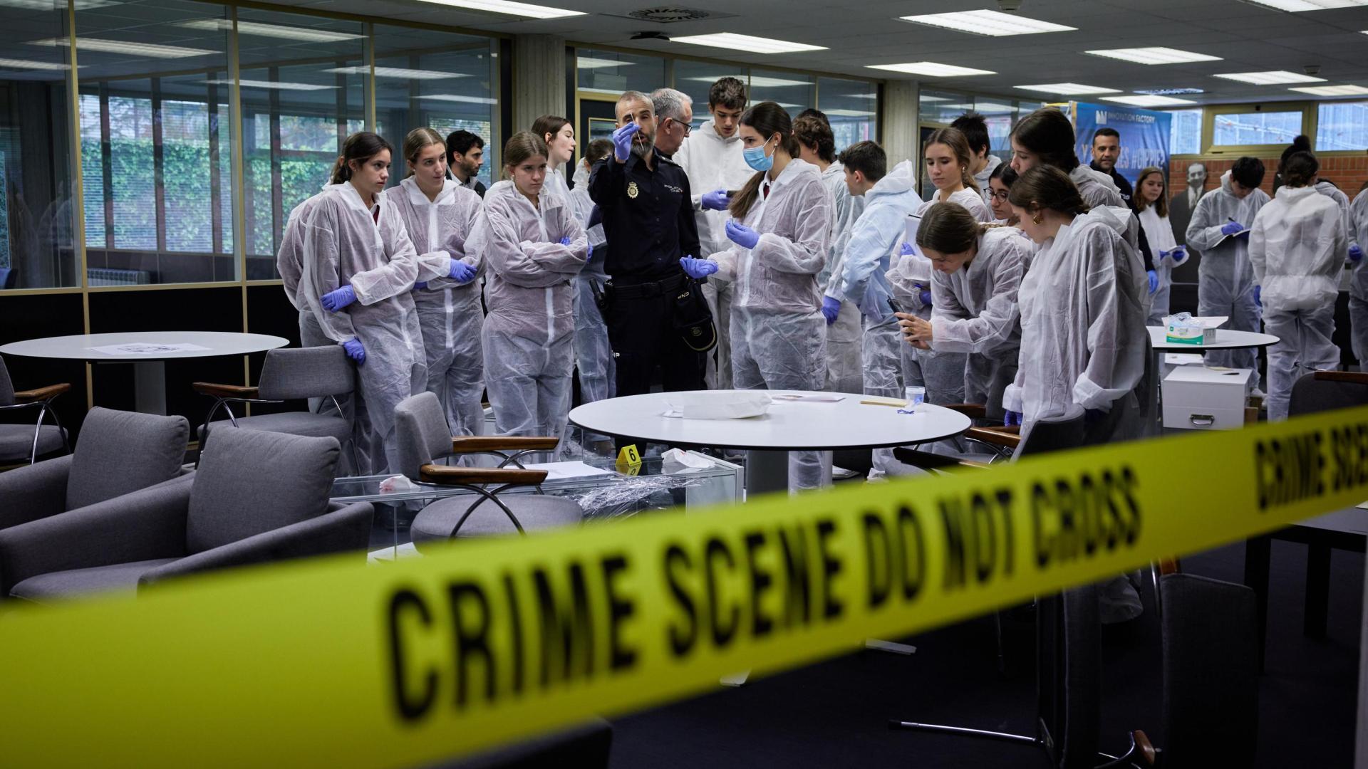 Un agente de la Policía Nacional explica a un grupo de alumnos la dinámica de la investigación