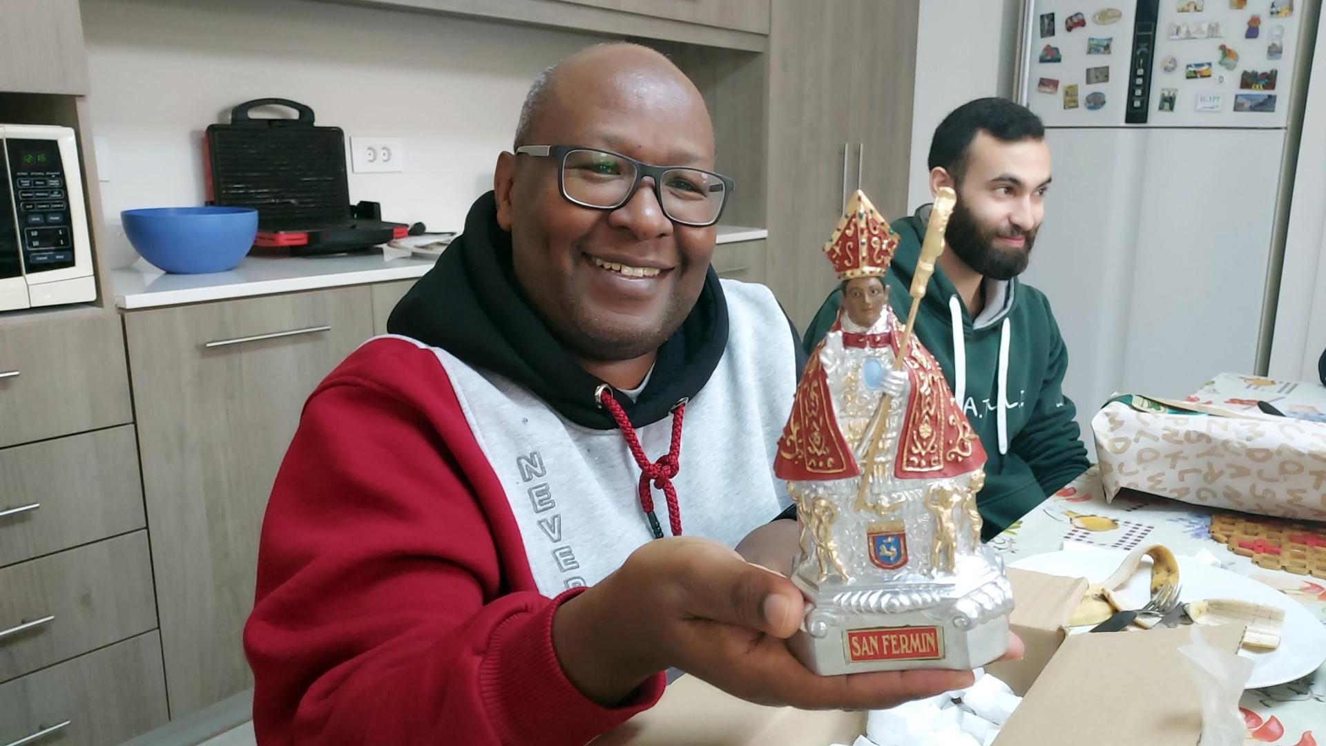 Maurice, hermano ruandés de la comunidad Fratelli, al recibir la figura de San Fermín.