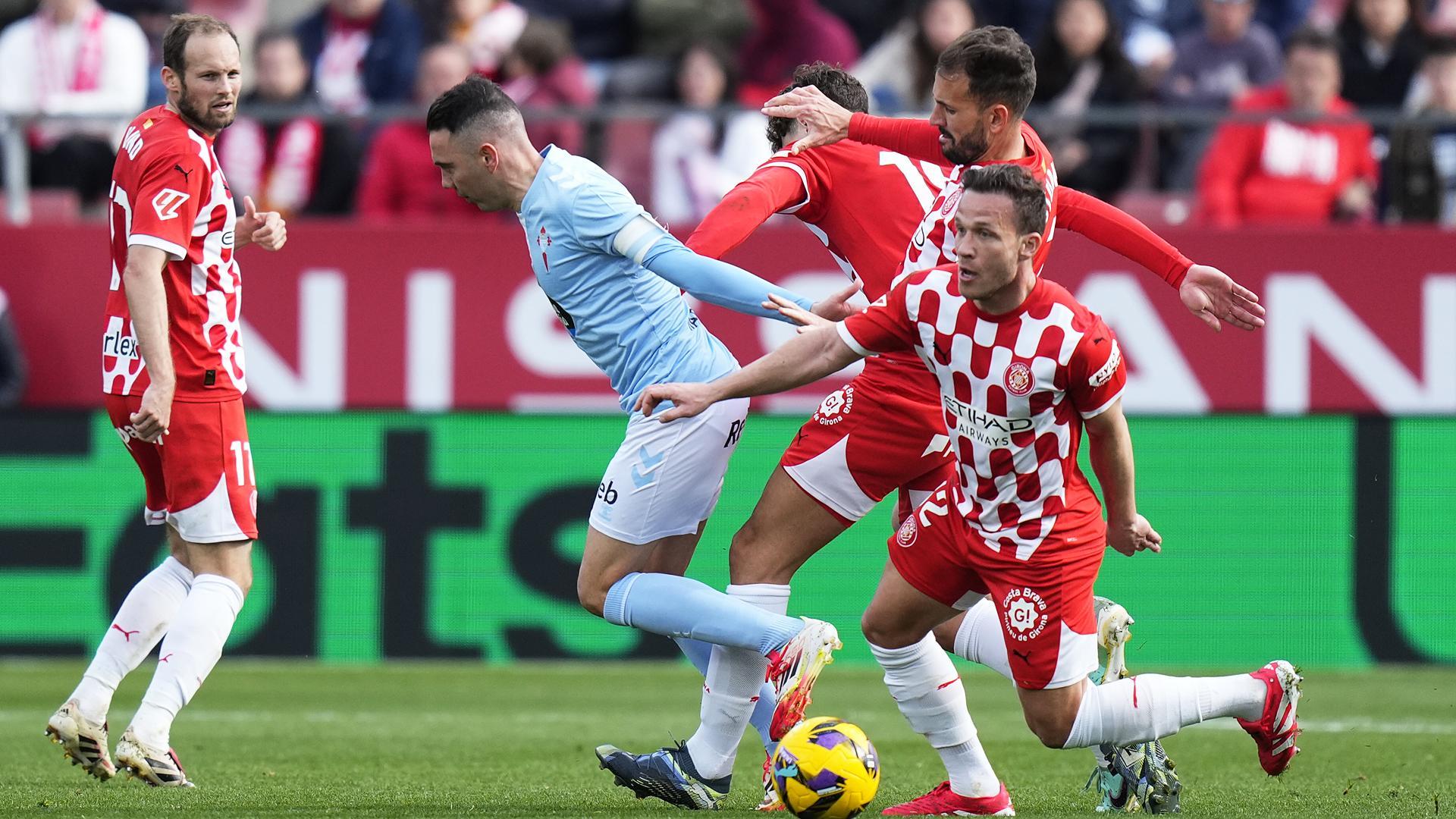 Arthur Melo, del Girona, trata de frenar a Iago Aspas durante el encuentro /