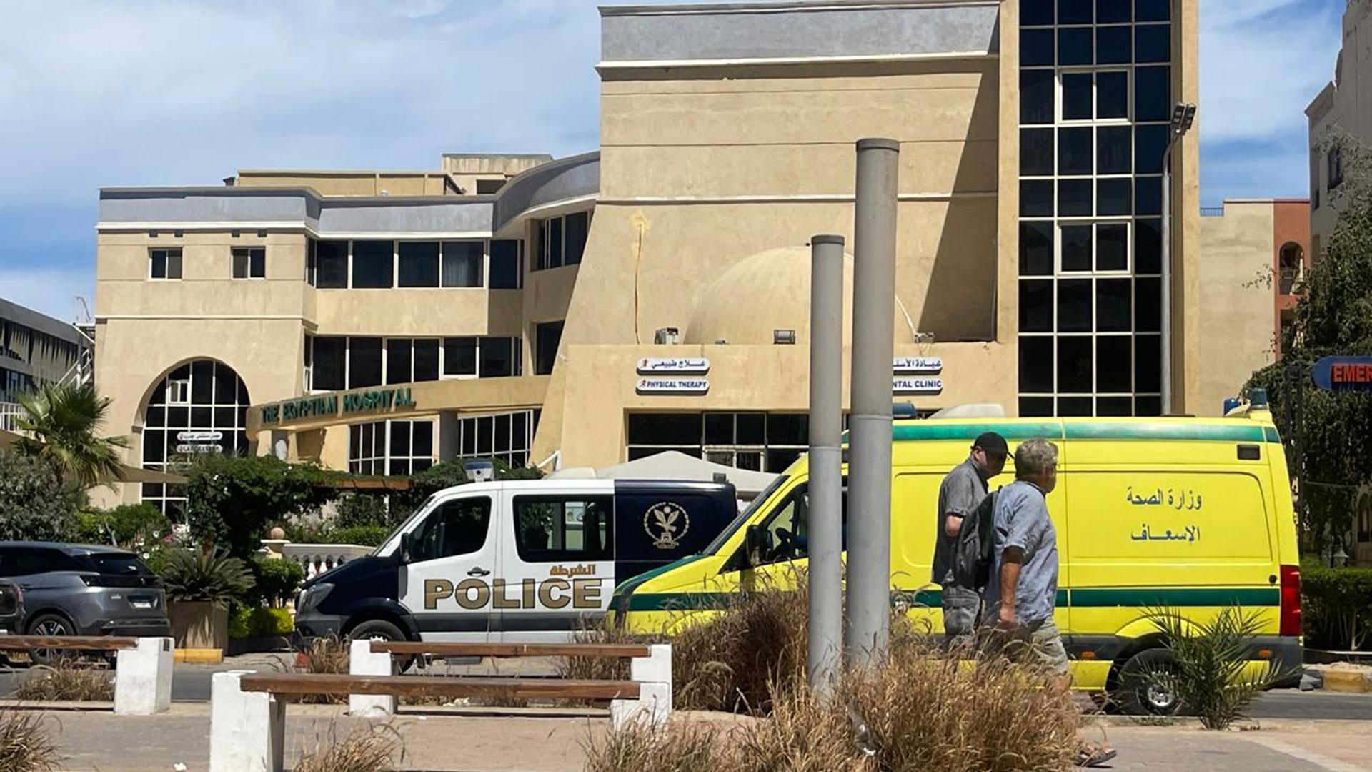 Dos hombres pasan delante del hospital donde han sido transportados los cuerpos de los seis turistas extranjeros fallecidos en el accidente del submarino, en Hurgada este jueves.