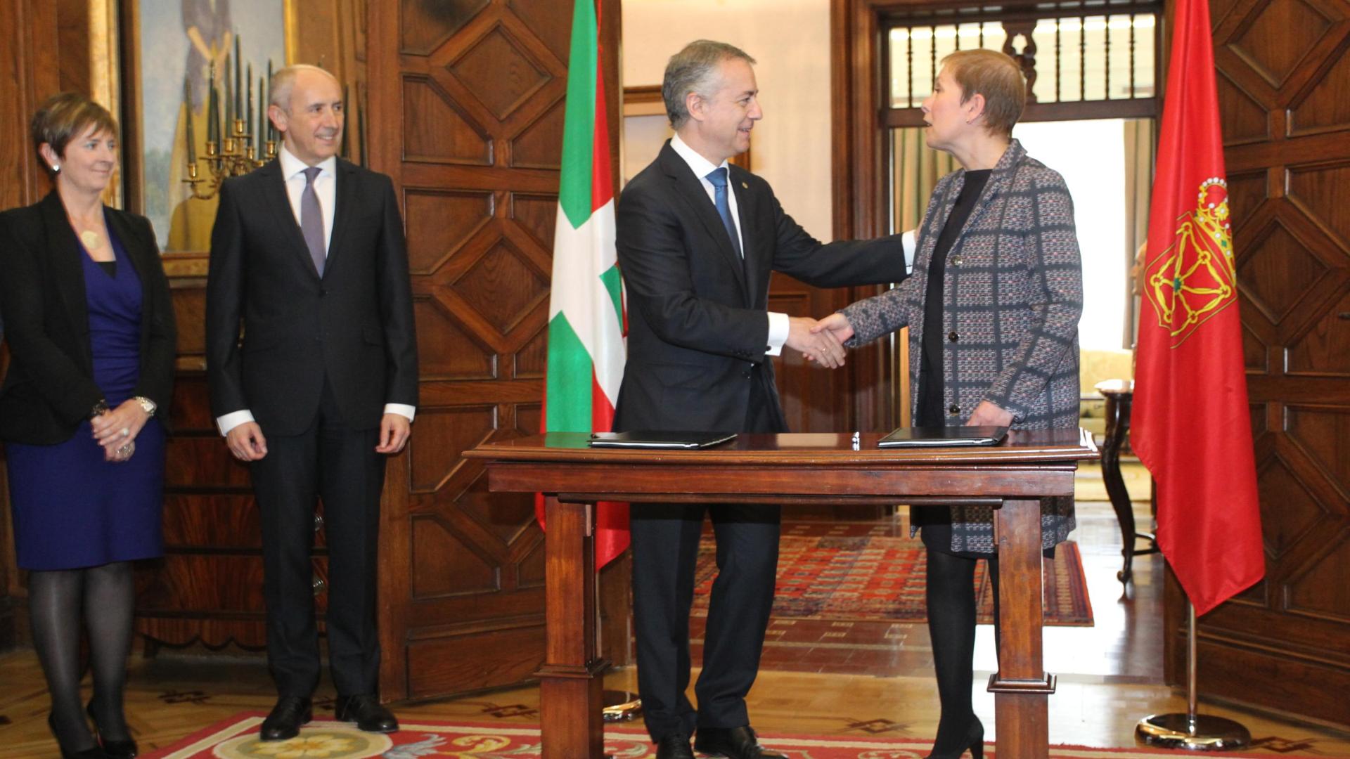 Iñigo Urkullu y Uxue Barkos, en el acto de firma del protocolo de 2016 en Ajuria Enea, con las banderas de Euskadi y Navarra