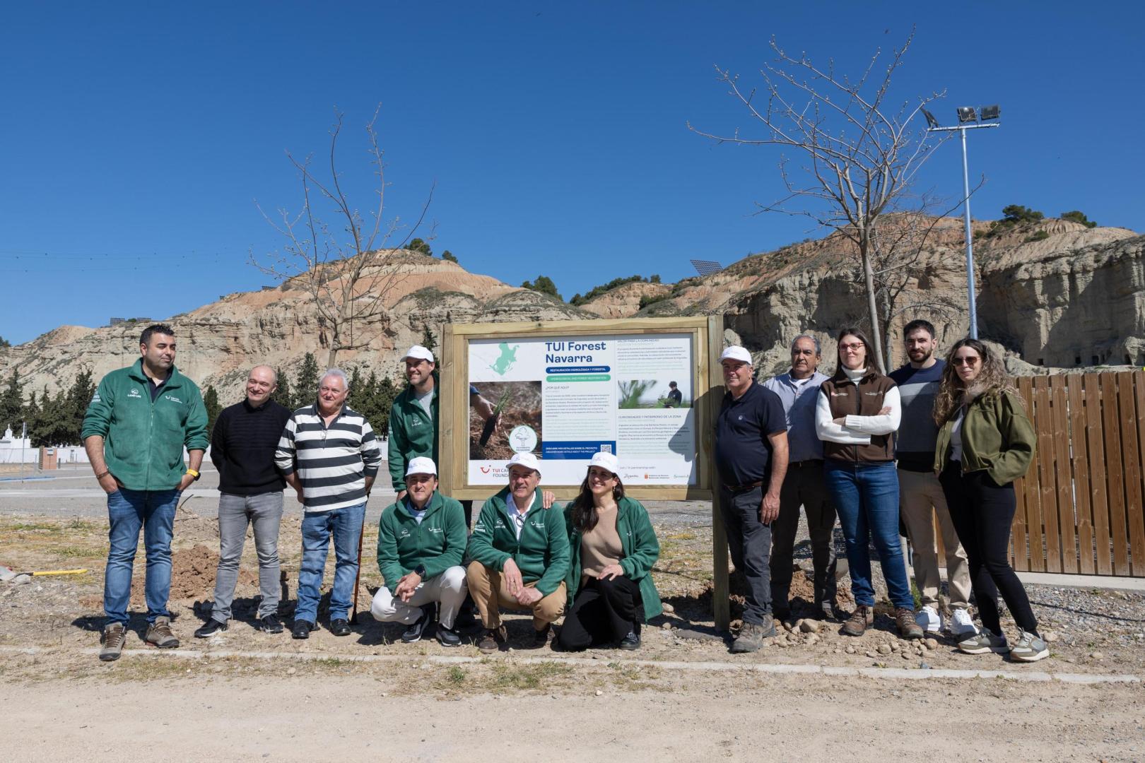 Imagen de los asistentes a la presentación este miércoles en Arguedas del proyecto TUI Forest Navarra, de restauración de 91 hectáreas de monte afectadas por el incendio de 2022 y que, posteriormente, participaron en una plantación simbólica de varios árboles junto al futuro parking de caravanas de esta villa ribera