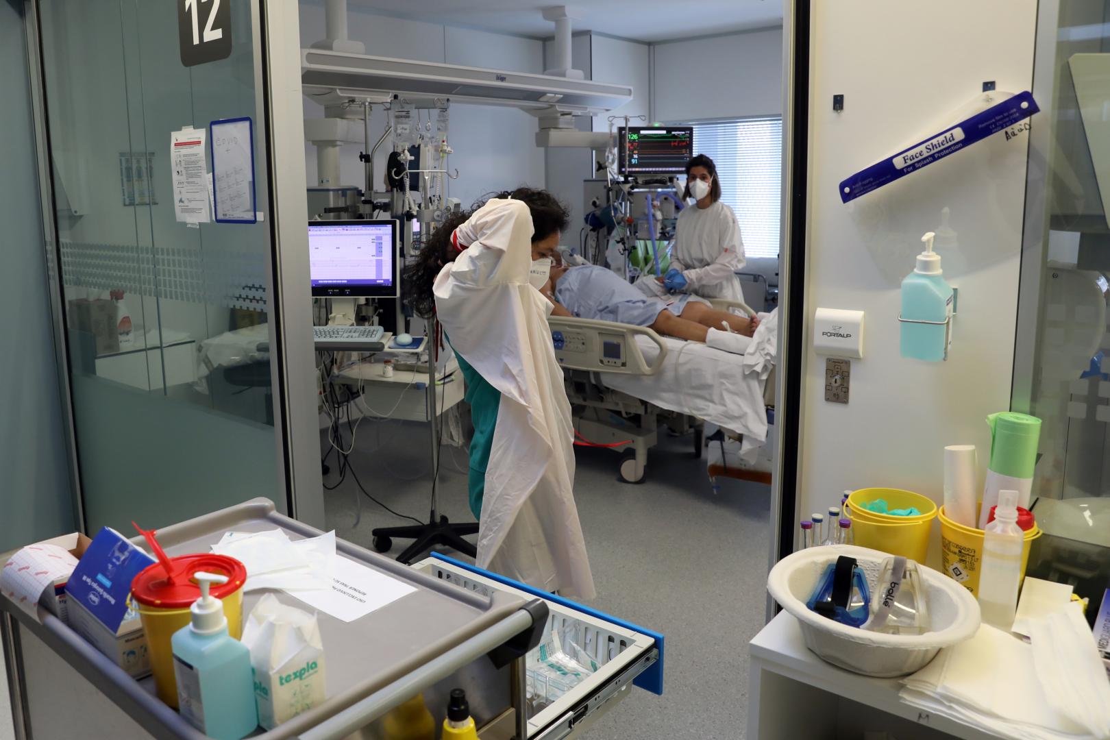 Una médico pasa delante de un box de la UCI del Hospital Universitario de Navarra, ayer por la mañana