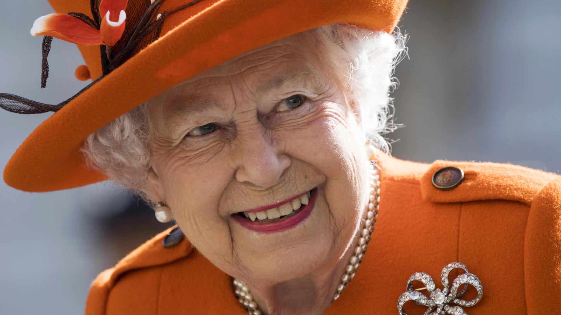 Imagen de la reina Isabel II, vestida con abrigo y sombrero naranja