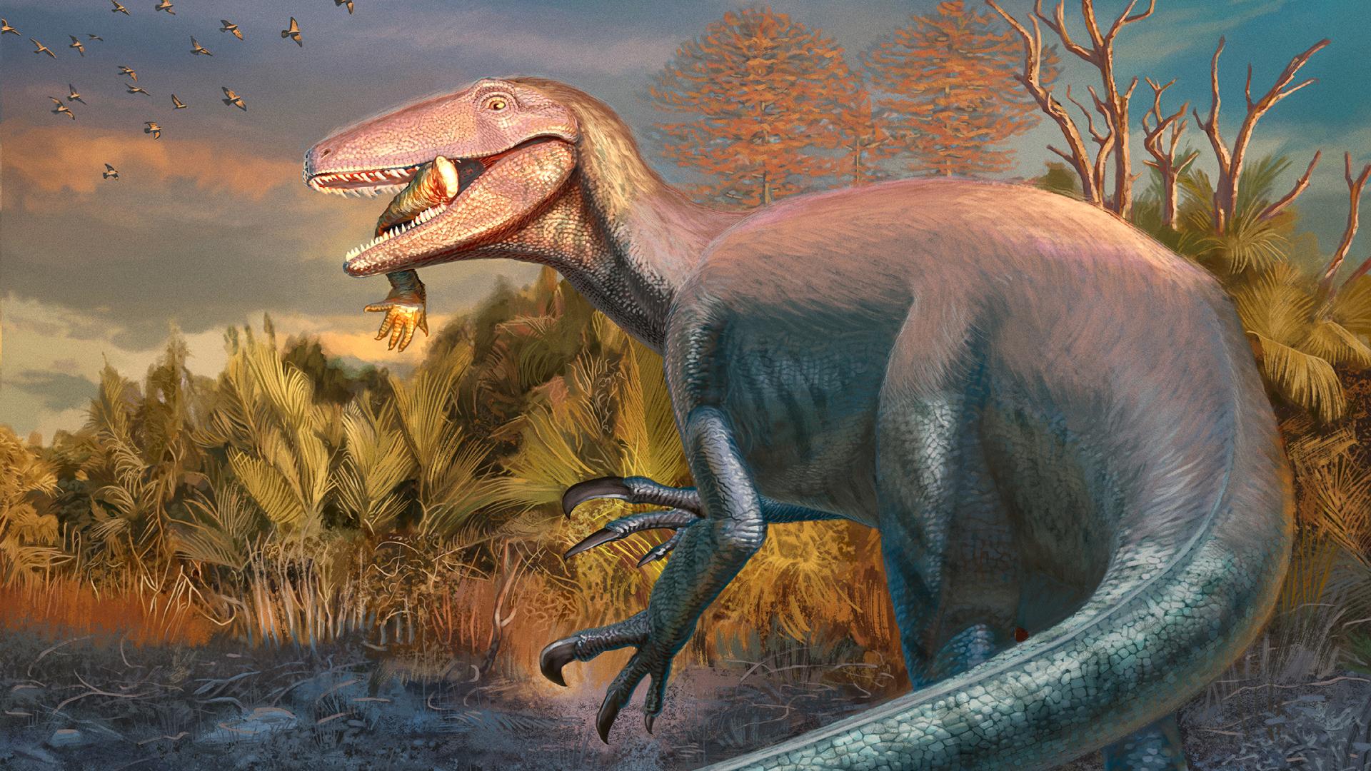 Una recreación del Joaquinraptor Casali, con el brazo de un cocodrilo entre los dientes