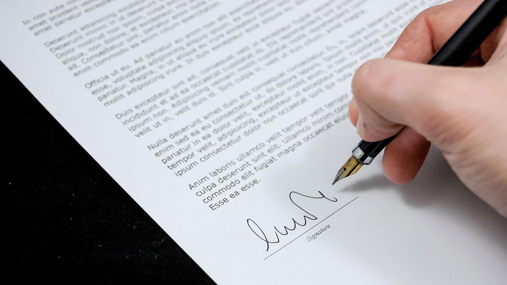 Una persona firmando un documento
