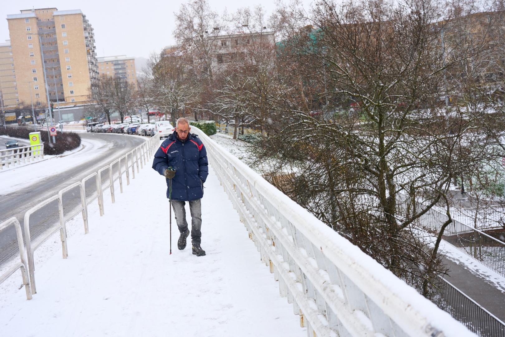 Un hombre camina con precaución por el puente de San Jorge, en Pamplona