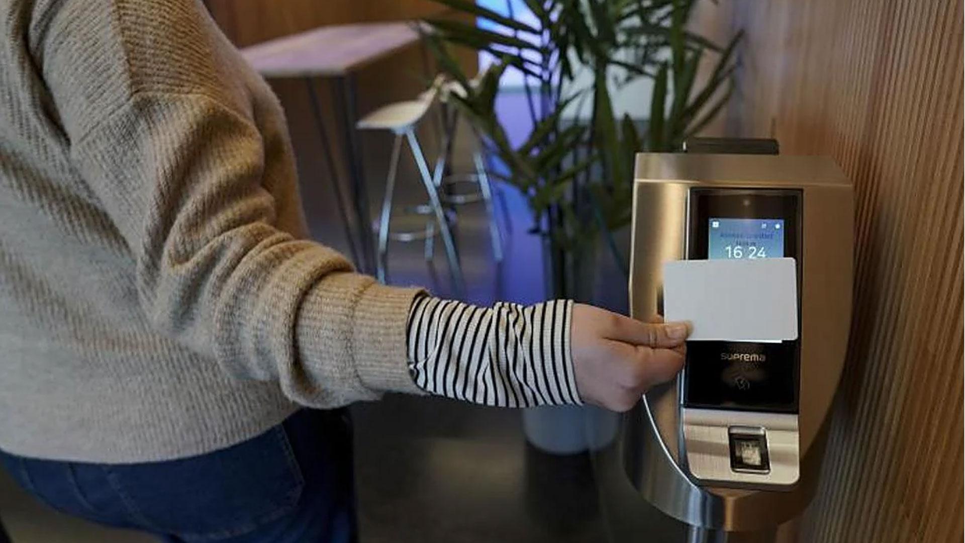 Una trabajadora ficha en el control de acceso a su empresa