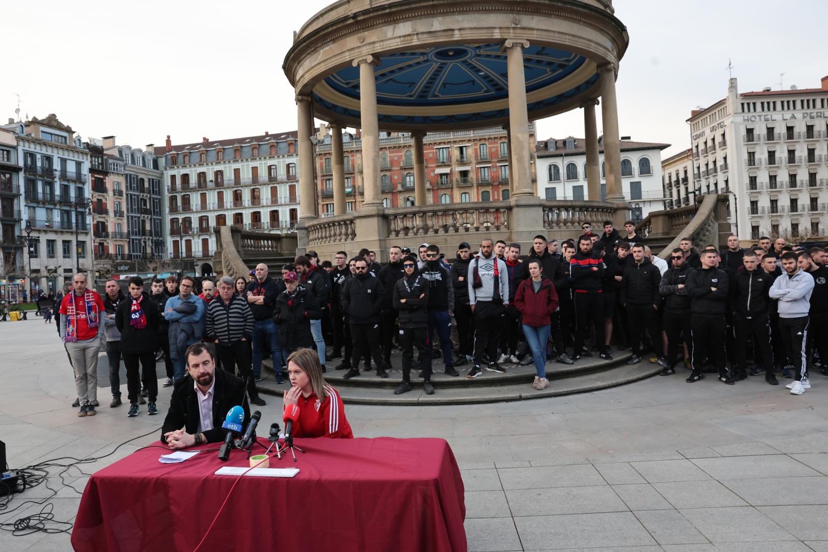 El colectivo Sadar Bizirik, con Miguel Azcona e Iraia Lizarraga en la mesa, en su comparecencia de este viernes en la Plaza del Castillo