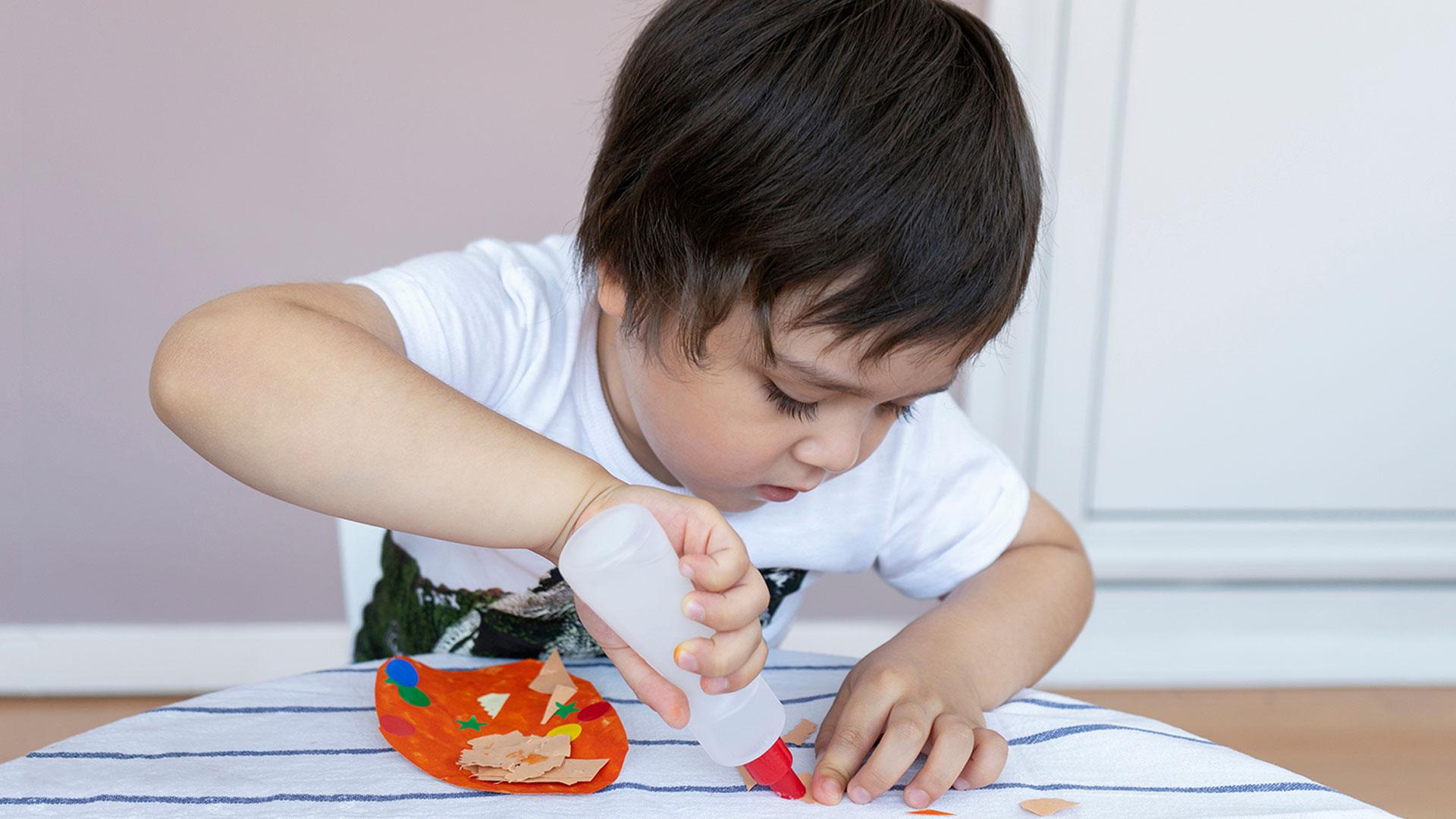 Un niño jugando con pegamento