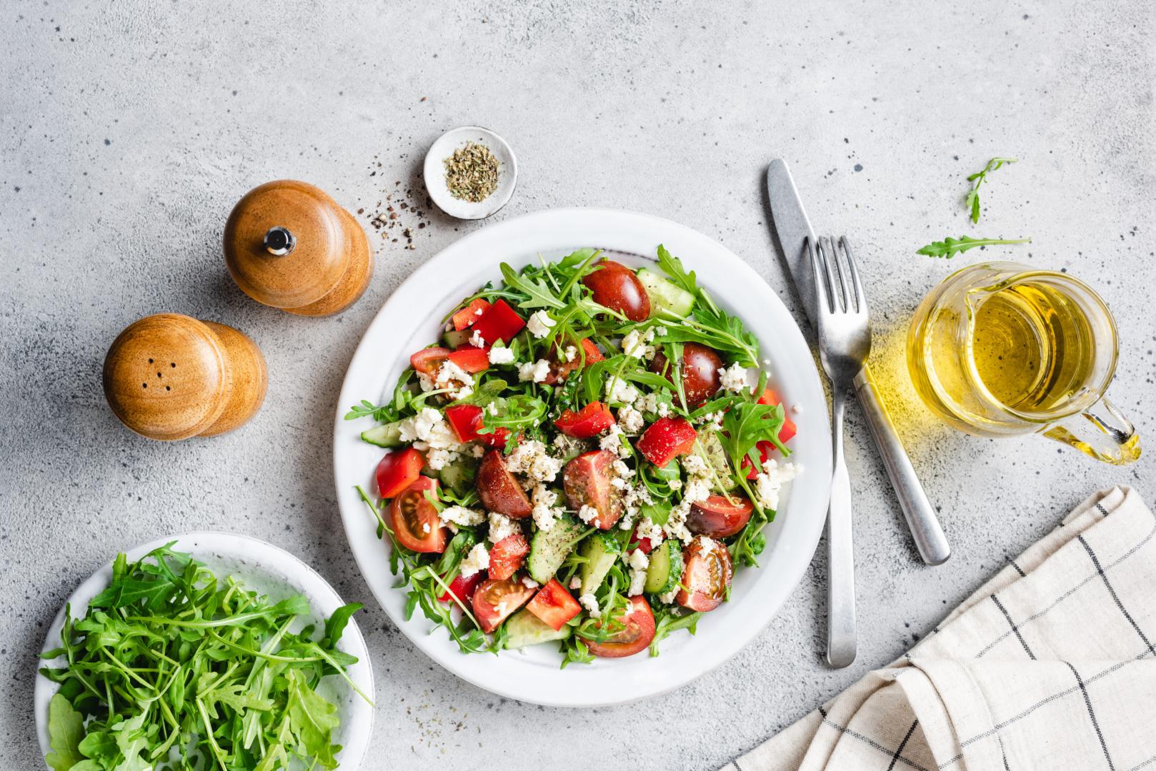 Healthy vegetable salad with arugula, tomatoes and goats cheese