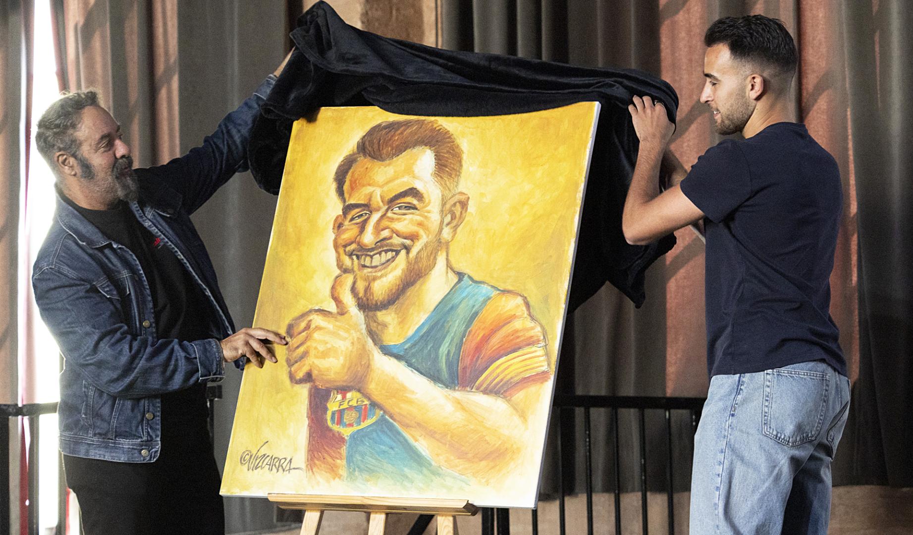 El central del Barcelona Eric Garcia der junto al caricaturista Joan Vizcarra iz , durante la presentación de la vigésima primera edición del libro 'Relatos Solidarios del Deporte'