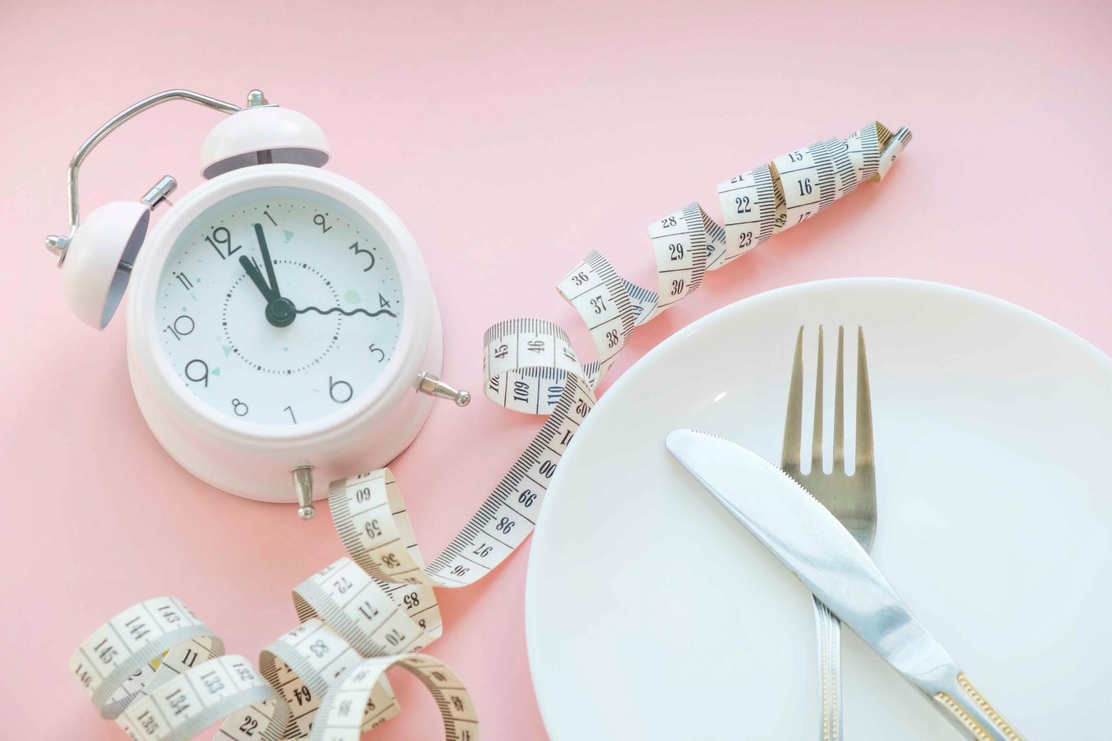 Time to lose weight , eating control or time to diet concept , alarm clock with healthy tool concept decoration on blue background