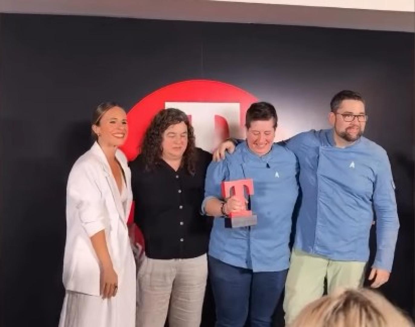 La influencer pamplonesa Laura Santolaya (izda.) entrega el premio al equipo de Amatxo: Marga Portas y Amaya Larraza