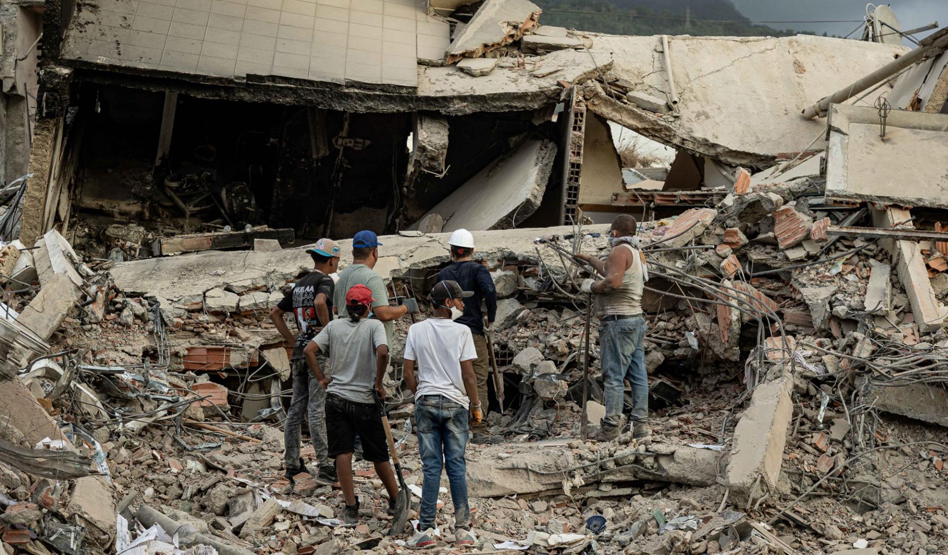 Personas participan en labores de búsqueda en un edificio afectado por un terremoto, este sábado en La Guaira (Venezuela).