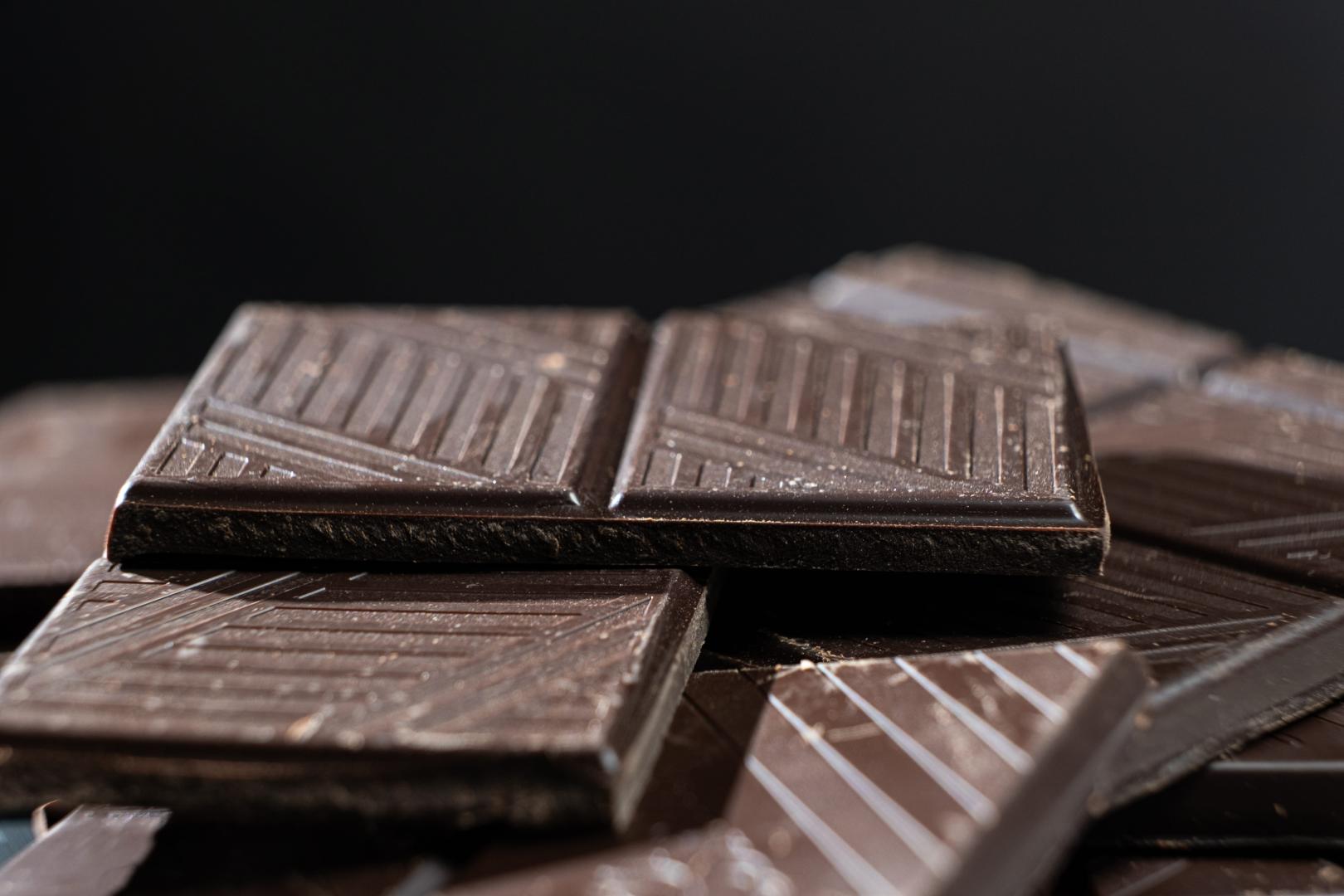 Delicious dark chocolate segments, rich black chocolate texture.