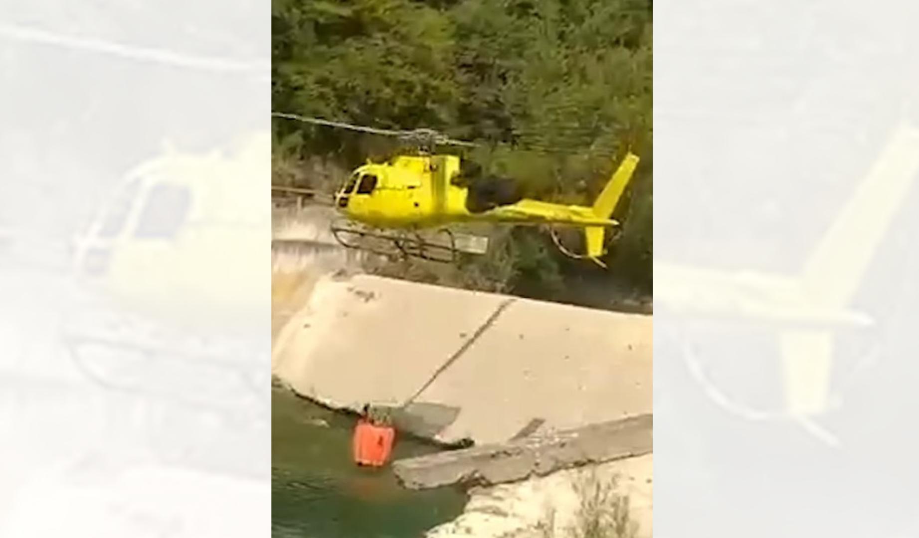 Helicóptero que coge agua del río Esca, en la presa del molino de Garde, durante el incendio de Urzainqui