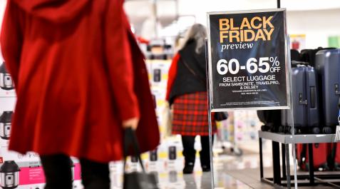 Clientas pasando junto a un cartel del Black Friday Clientas pasando junto a un cartel del Black Friday