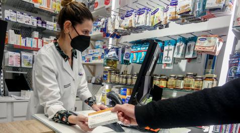 Una farmacéutica dispensa un autotest covid Una farmacéutica dispensa un autotest covid