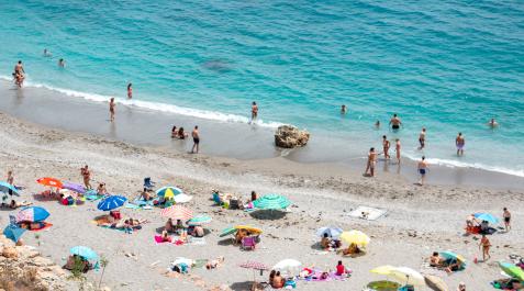 Varias personas disfrutan de la playa de la Rijana (Castell de Ferro)