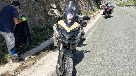 Motorista Un compañero del motorista accidentado junto a la motocicleta en el lugar del accidente