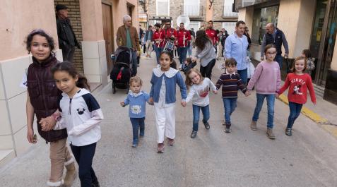 Niños y adultos preceden a la charanga durante el pasacalles posterior al lanzamiento del cohete