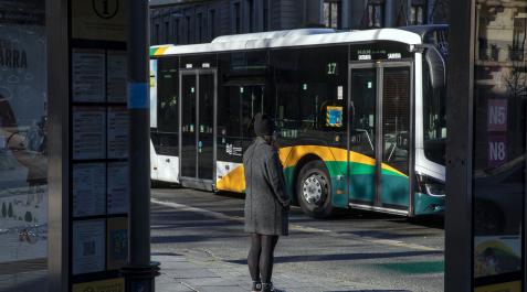 villavesas Una persona espera en una parada del transporte urbano comarcal en Pamplona.