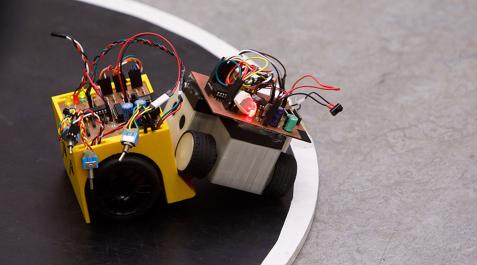 Un robot de minisumo expulsa a otro del tatami en una de las competiciones celebradas en la UPNA Un robot de minisumo expulsa a otro del tatami en una de las competiciones celebradas en la UPNA