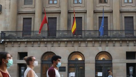 Varias personas caminan ante la fachada del Palacio de Navarra, sede del Gobierno foral, en la Avenida Carlos III