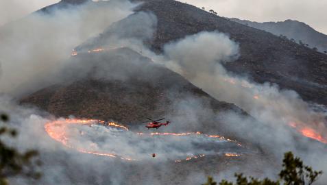 Un helicópetero trabaja en las labores de extinción del incendio de Sierra Bermeja