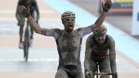 Sonny Colbrelli, cubierto de barro, celebra su victoria en la meta de Roubaix