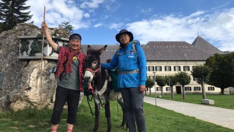 Los coreanos Taxi y Lee flanquean al pollino Meski, de Astotrek, en el inicio de la ruta jacobea en Roncesvalles
