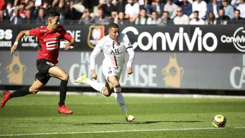 Kylian Mbappe se marcha del jugador del Rennes, Nayef Aguerd, durante un encuentro de liga