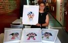 Silvia Lorrio junto con sus acuarelas Sanfermineras en la exposición del bar Viva San Fermín.