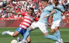 Luis Suárez, delantero del Granada, se lanza al suelo para pelear por el balón con un jugador del Celta