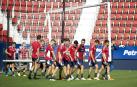 Los jugadores rojillos transportan una portería durante la sesión de entrenamiento a puerta cerrada este jueves en El Sadar