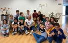Óscar López -sentado- junto a varios de los alumnos del colegio de Cadreita que visitaron su exposición