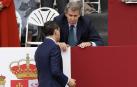 El líder del PP, Alberto Núñez Feijóo (d) conversa con el presidente de Andalucía, Juanma Moreno (i) antes del desfile de las Fuerzas Armadas con motivo de la Fiesta Nacional en la tribuna de autoridades este domingo